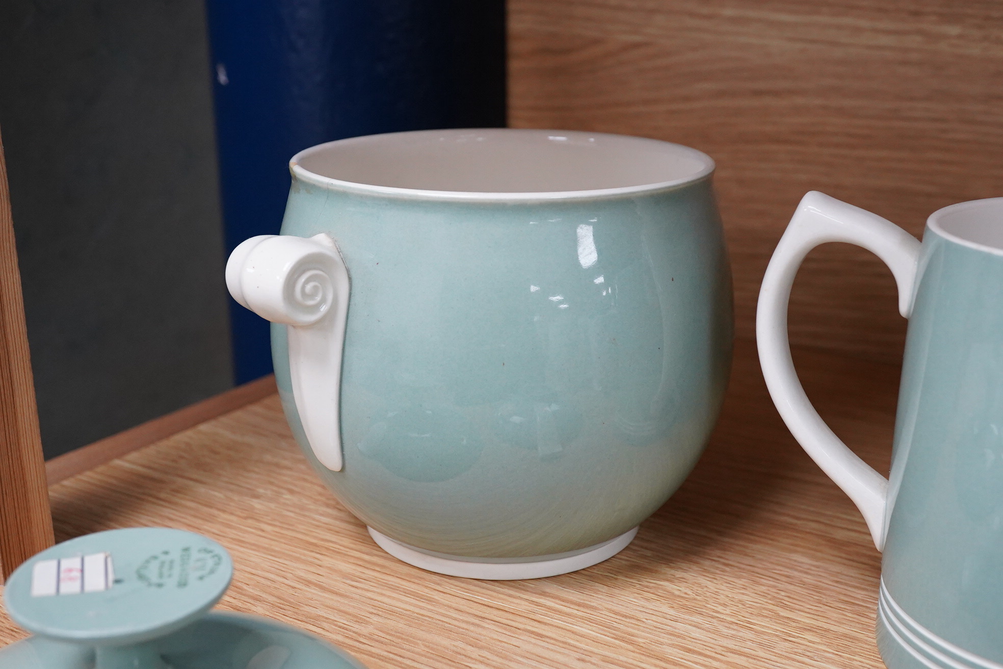 Keith Murray for Wedgwood - a celadon mug, two handled vase and two tazzas, tallest 13cm